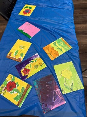 A table with paintings of flowers on it.