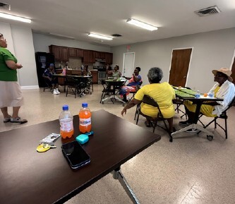 People sitting playing Bingo with one person standing.