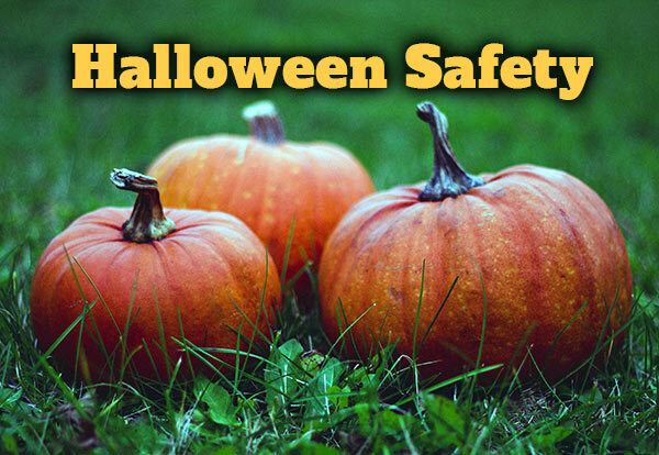 Three pumpkins in the grass with the words Halloween Safety.