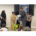 A man presents a certificate to a woman that is retiring. 