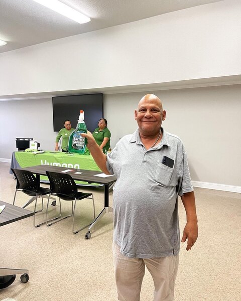 Man holding a bottle of spray cleaner.