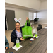 Woman with bunny ears holding a tote bag.