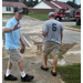 Two men walking on a street towards a fire truck.