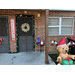 Wreath on the door with an inflatable bear and welcome sign.