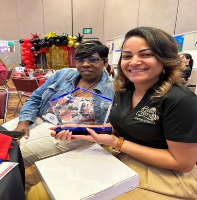Two women sitting next to each other and smiling for a picture at the SERC-NAHRO Annual Conference.